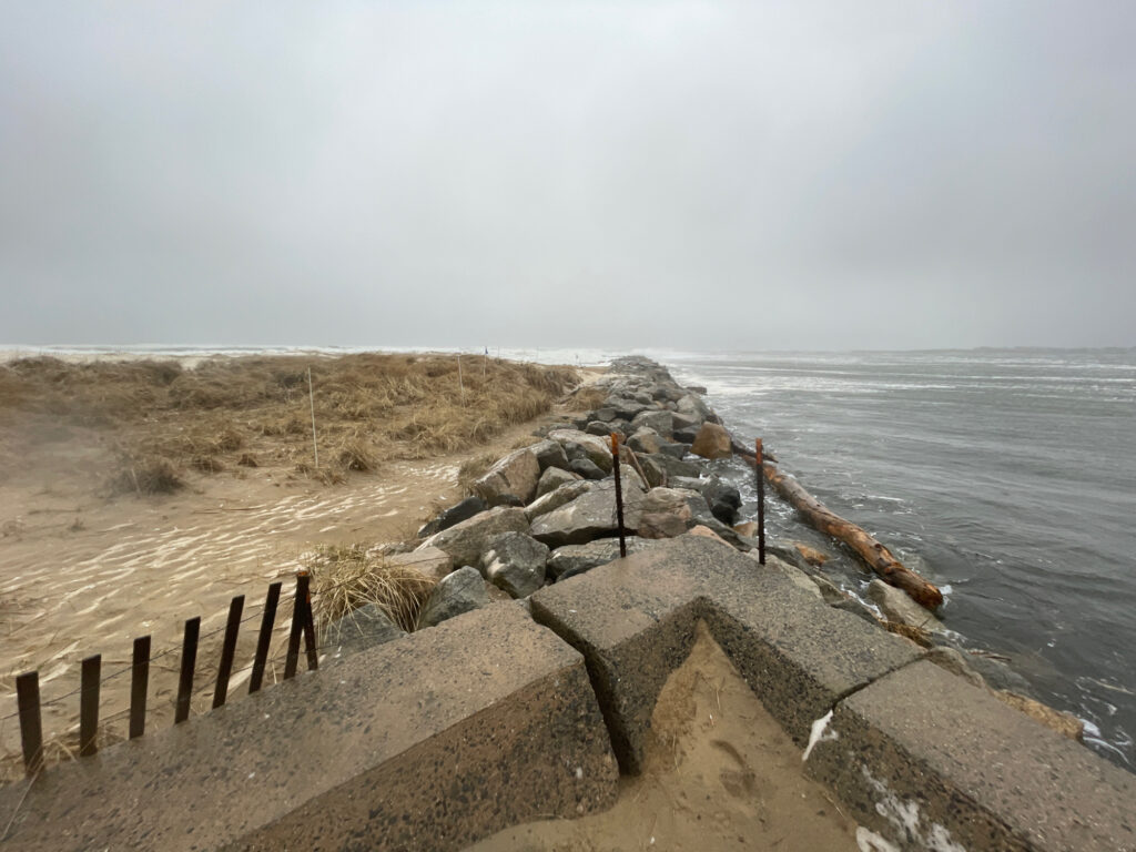 a rocky beach with a fence (MyCoast AI)