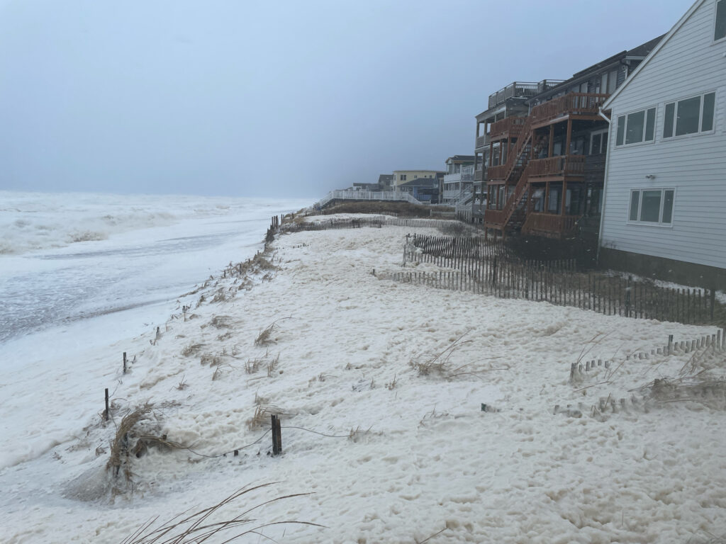 a snowy beach with buildings and a bridge (MyCoast AI)