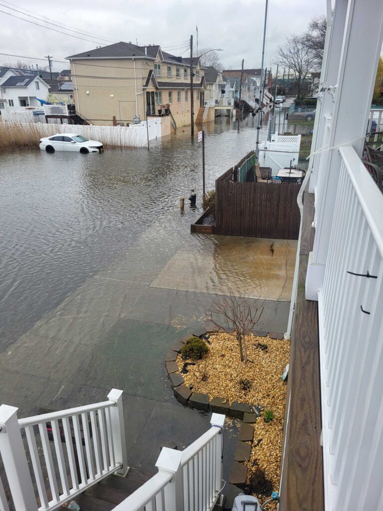 a flooded street with a boat (MyCoast AI)