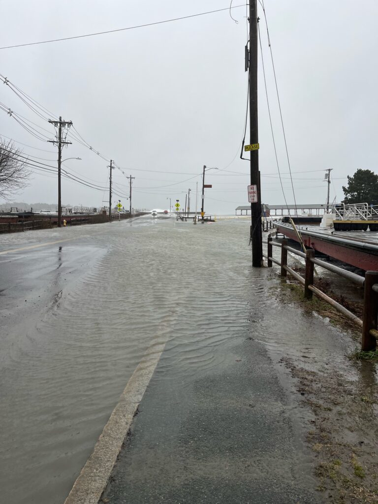 a flooded road with a pole and a boat on it (MyCoast AI)