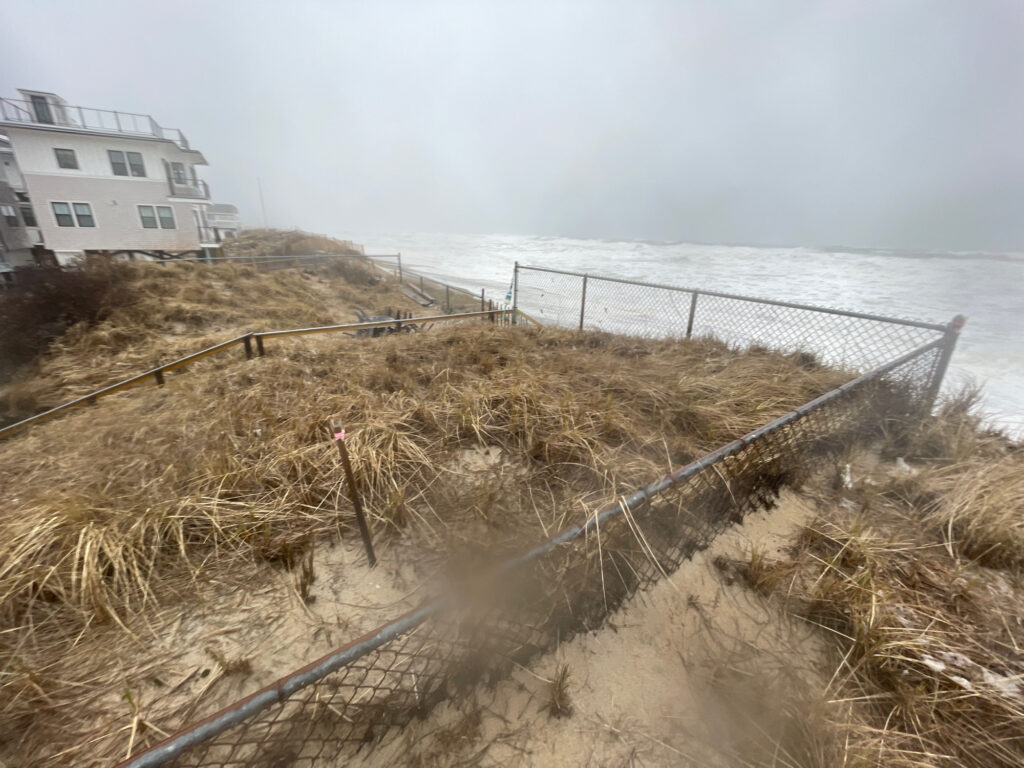 a fenced off area next to a building and a body of water (MyCoast AI)