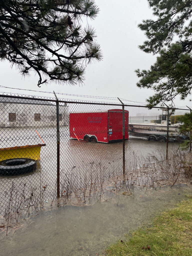 a red truck parked behind a fence (MyCoast AI)