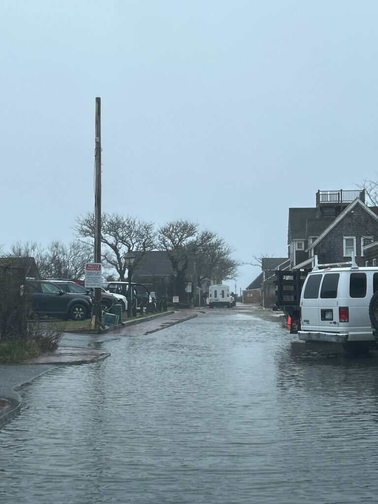 a flooded street with cars and houses (MyCoast AI)