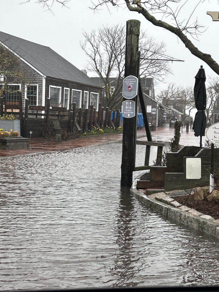 a flooded street with a sign (MyCoast AI)