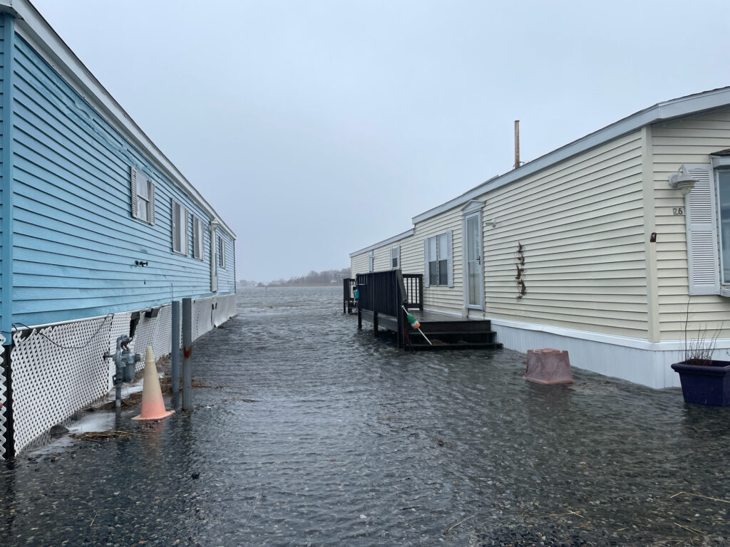 a row of buildings with a fence and a road (MyCoast AI)
