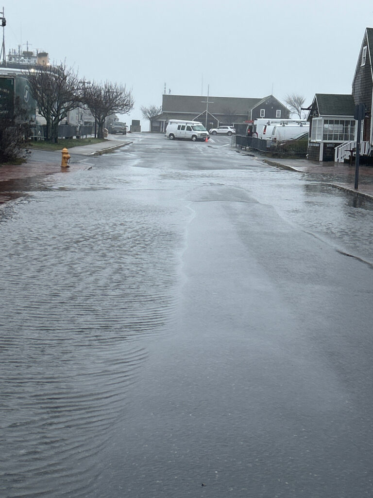 a flooded street with cars and buildings (MyCoast AI)