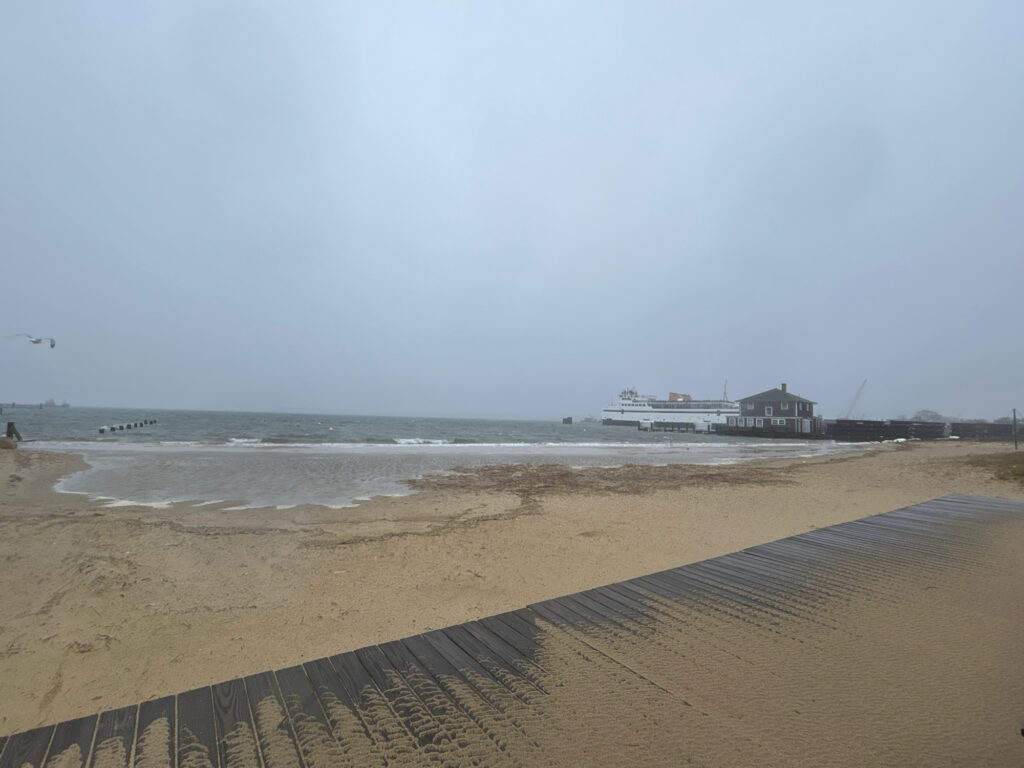 a sandy beach with a building in the distance (MyCoast AI)