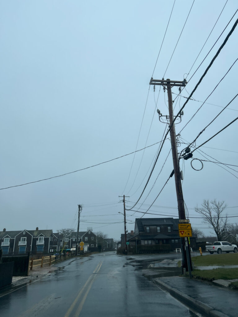 a road with power lines and buildings on the side (MyCoast AI)