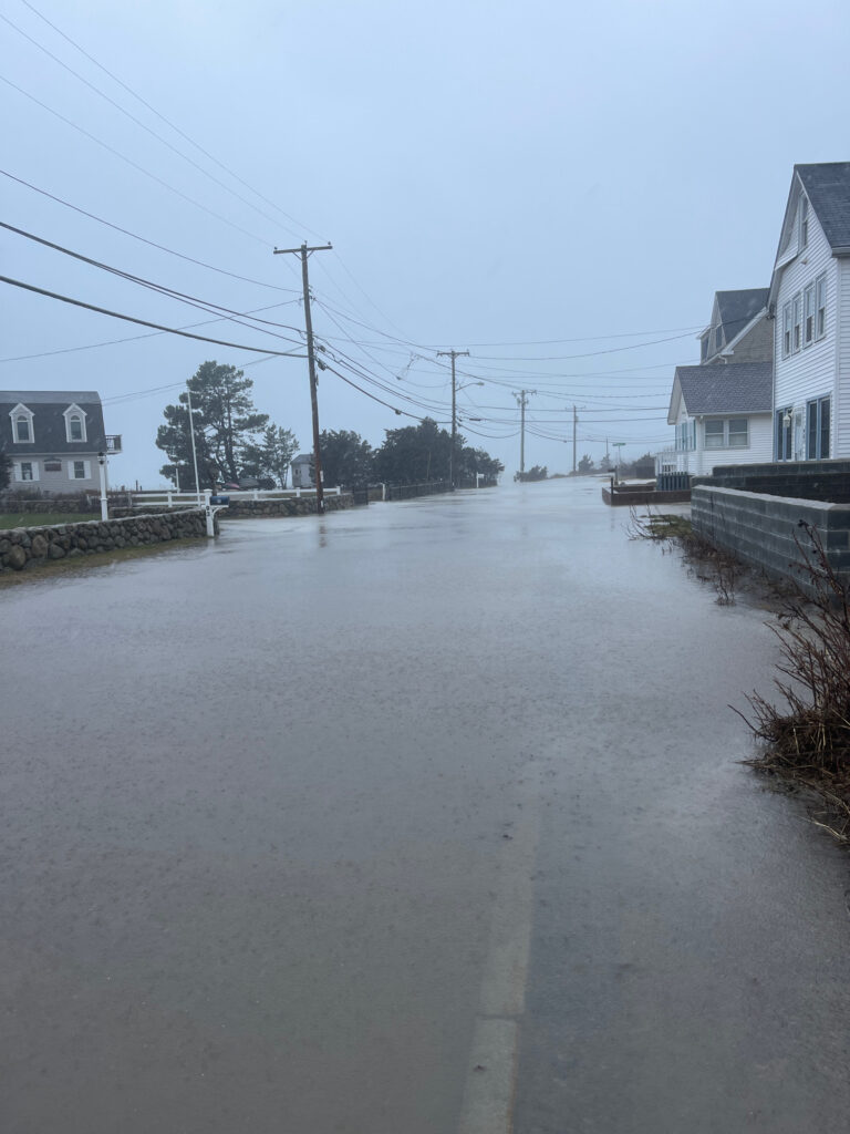a flooded street with houses on either side of it (MyCoast AI)
