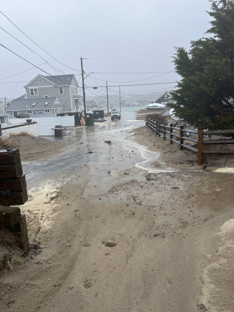 a flooded road with houses on either side of it (MyCoast AI)