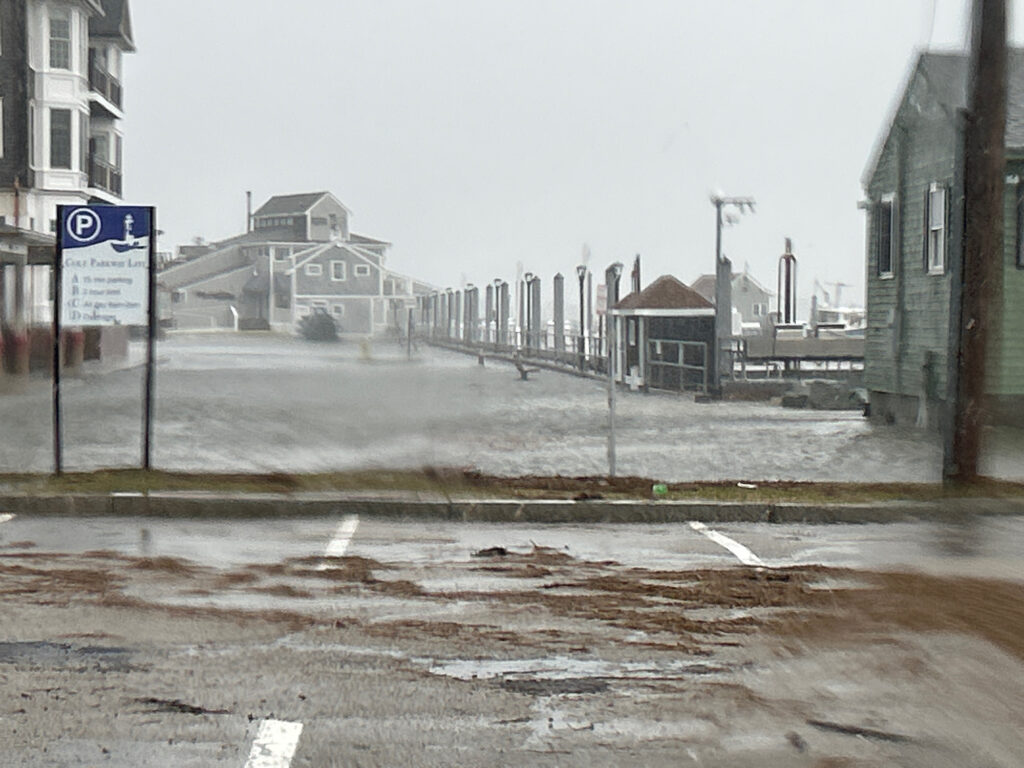 a wet street with buildings on either side of it (MyCoast AI)