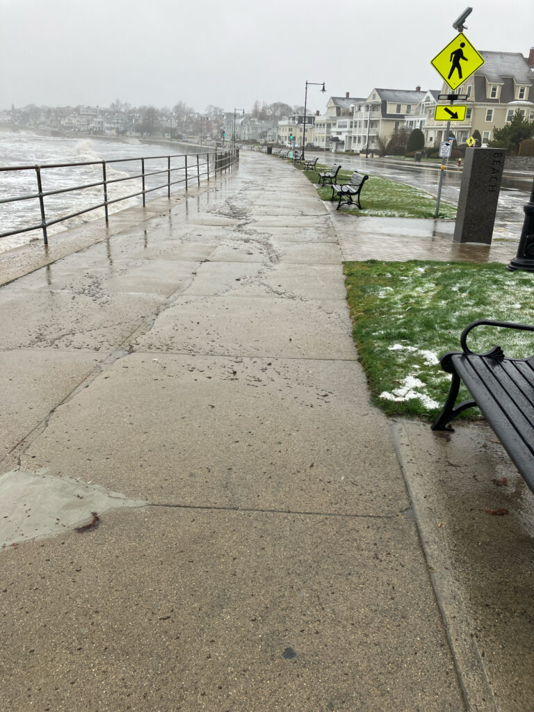 a sidewalk with benches and a sign (MyCoast AI)