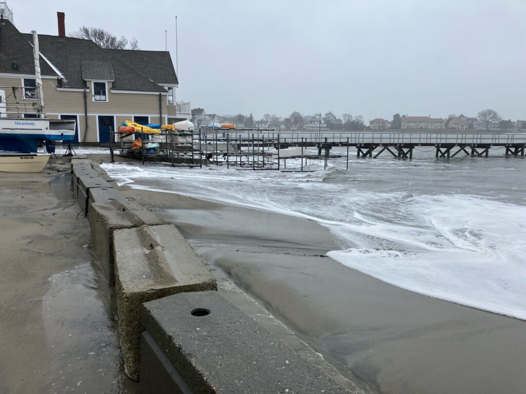 a pier with waves crashing against it (MyCoast AI)