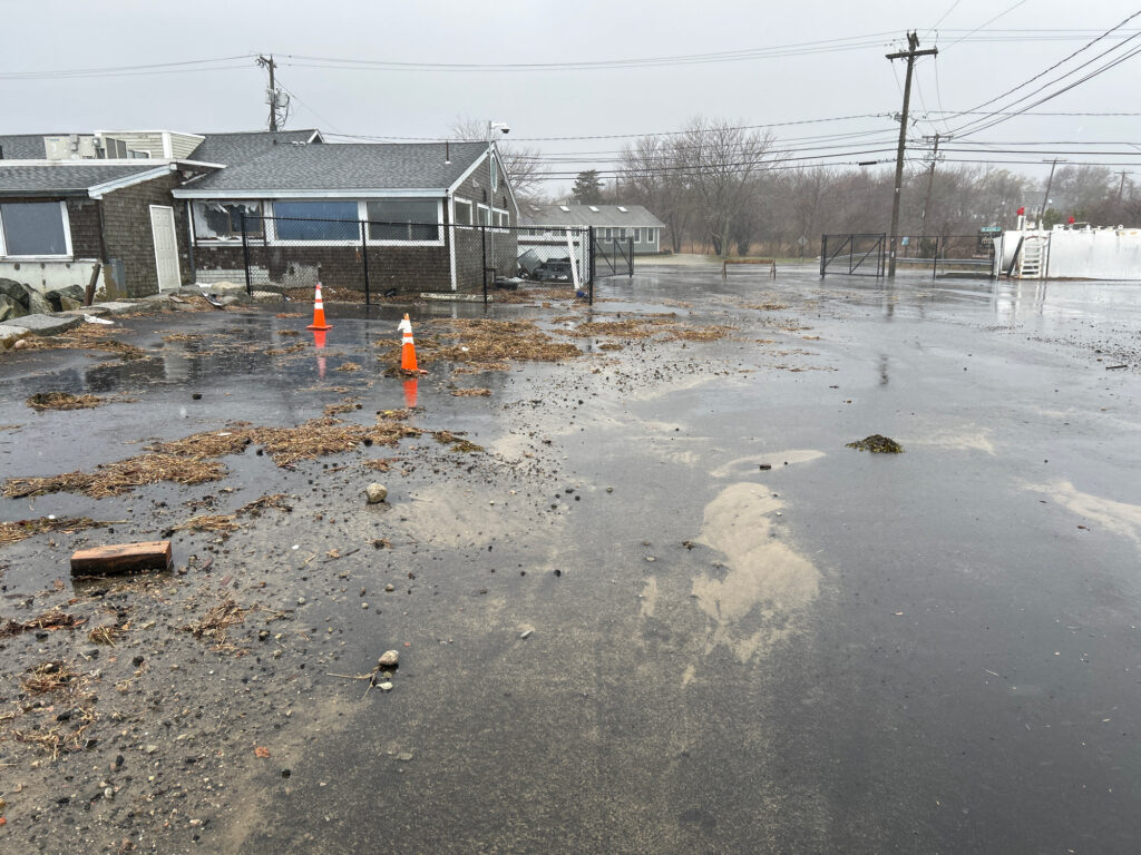 a flooded street with a house and a fence (MyCoast AI)