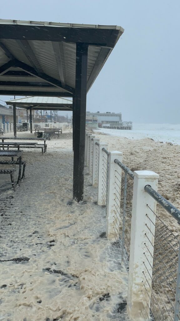 a covered area with a fence and a building in the background (MyCoast AI)