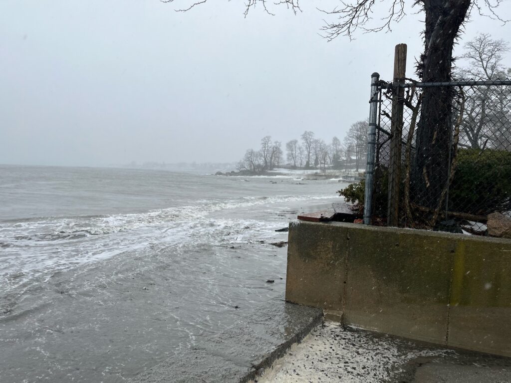 a body of water with a concrete wall and trees around it (MyCoast AI)