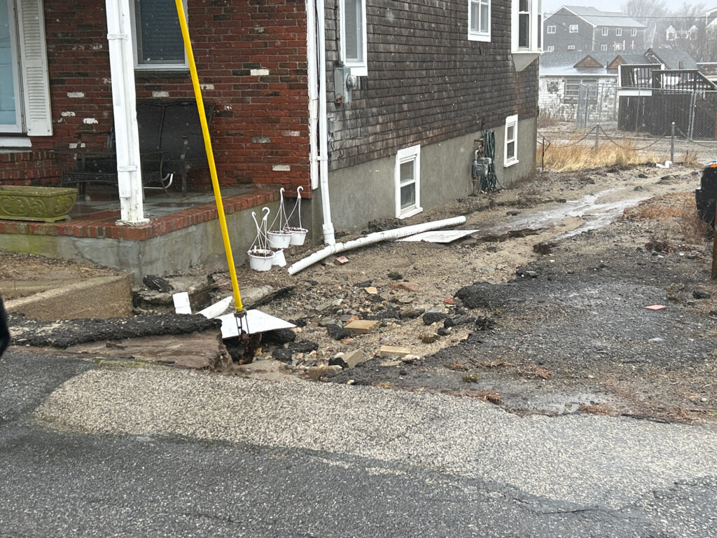 a pile of dirt next to a brick building (MyCoast AI)