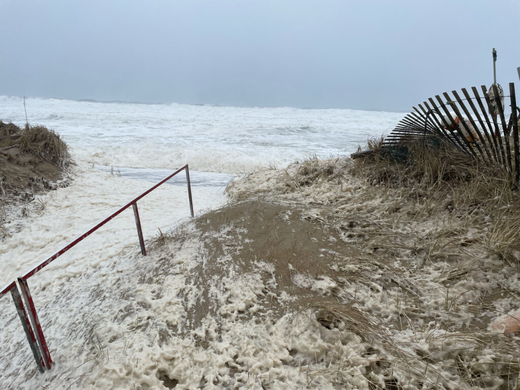 a sandy beach with a fence (MyCoast AI)