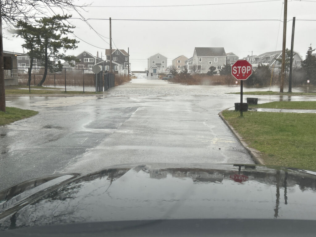 a wet street with a stop sign (MyCoast AI)