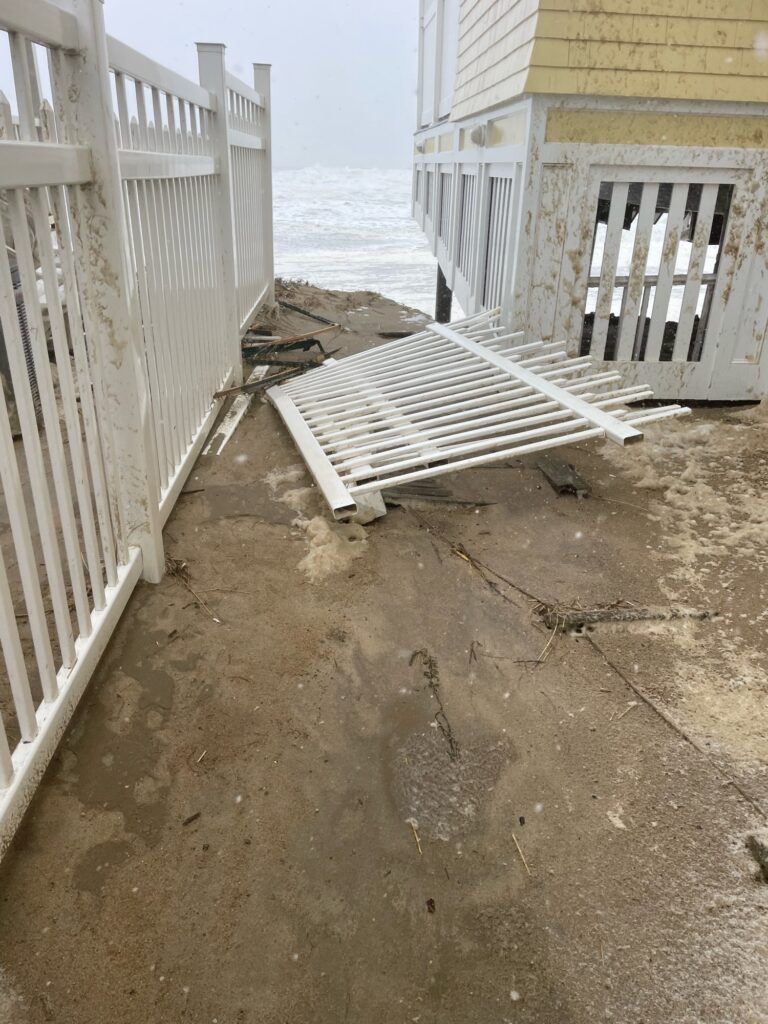 a white building with a white fence (MyCoast AI)