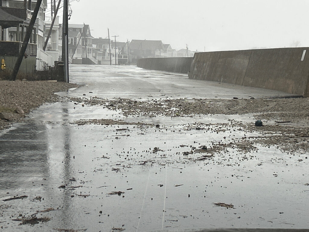 a wet road with buildings on the side (MyCoast AI)