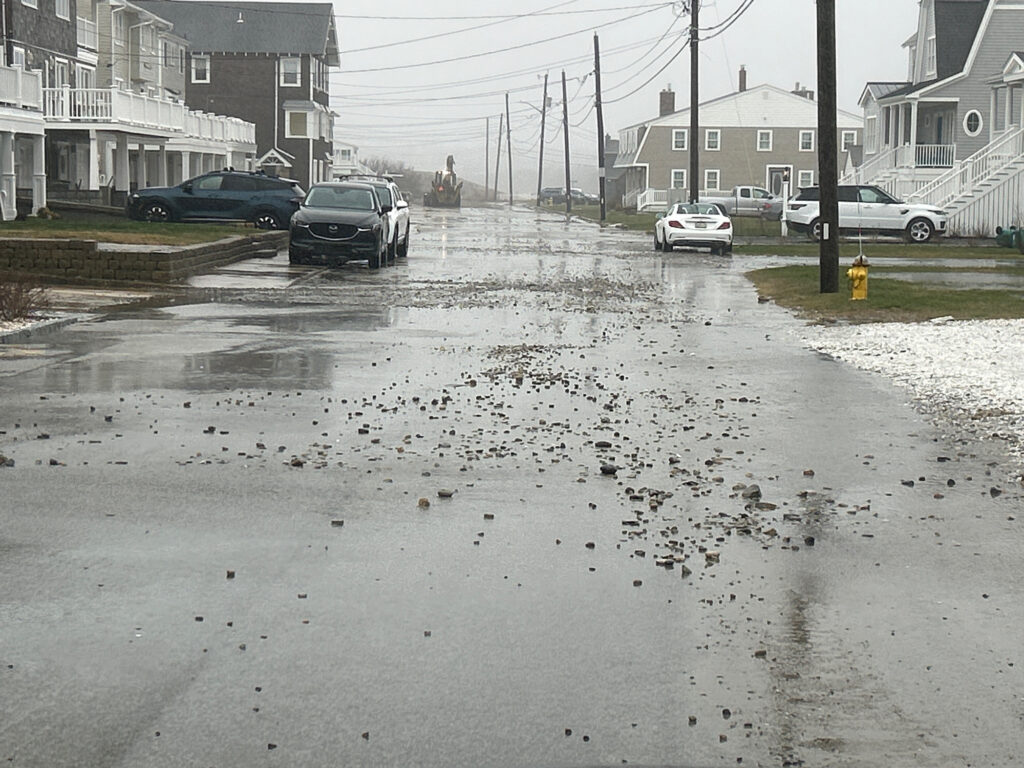 a wet street with cars parked on the side (MyCoast AI)