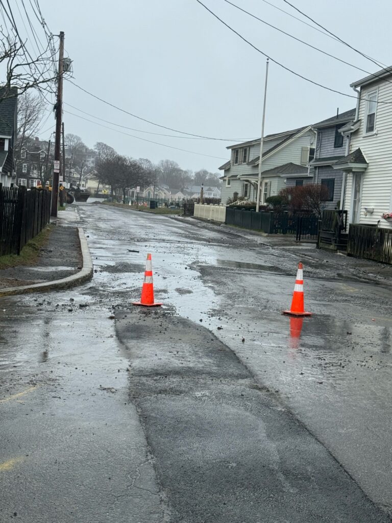 a road with a traffic cone on it and houses on the side (MyCoast AI)
