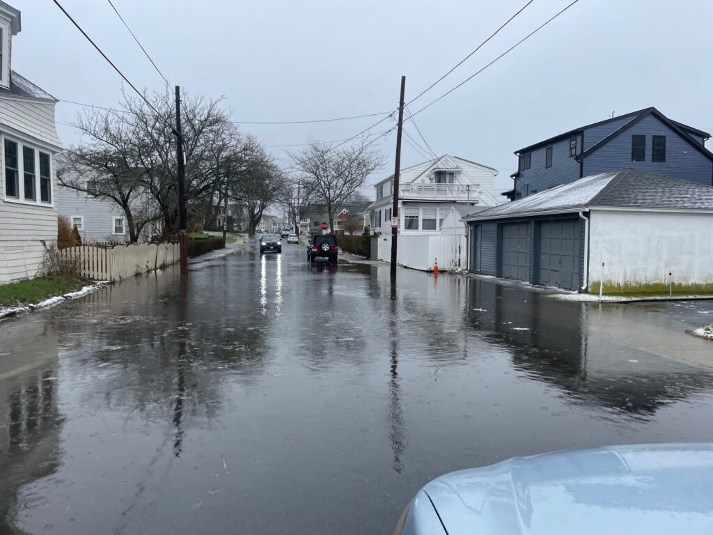 a flooded street with houses and cars (MyCoast AI)