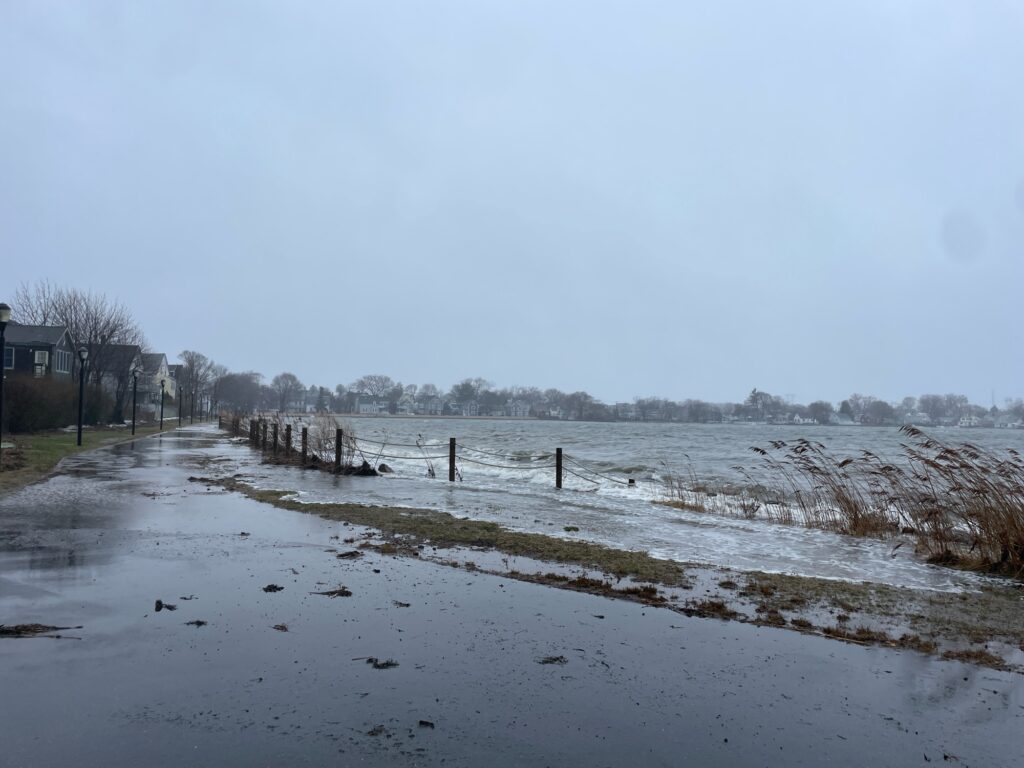 a frozen lake with a fence and trees in the background (MyCoast AI)