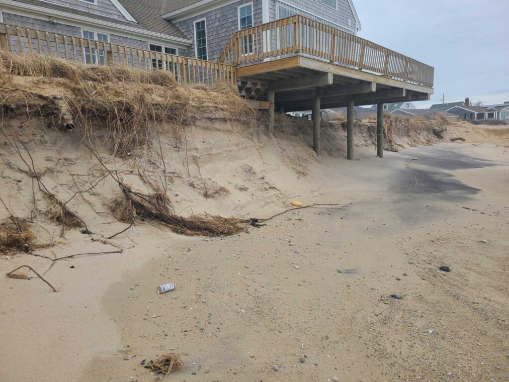 a beach with a pier and a building in the background (MyCoast AI)