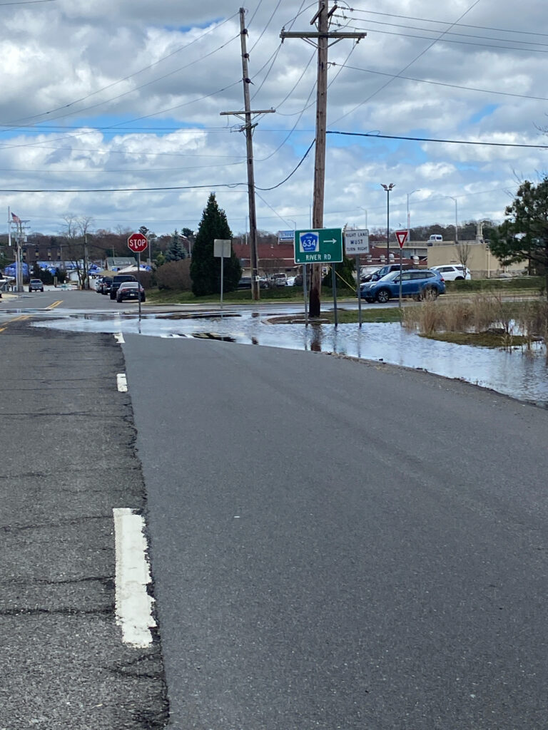 a flooded street with cars and power lines (MyCoast AI)