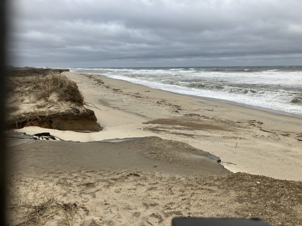a sandy beach with waves crashing on it (MyCoast AI)