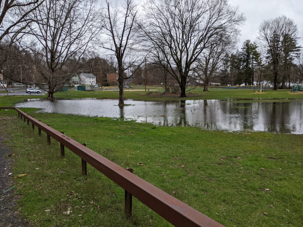 a wooden bench next to a river (MyCoast AI)