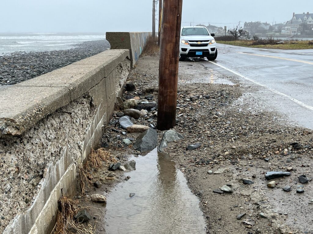 a car driving on a road next to a body of water (MyCoast AI)