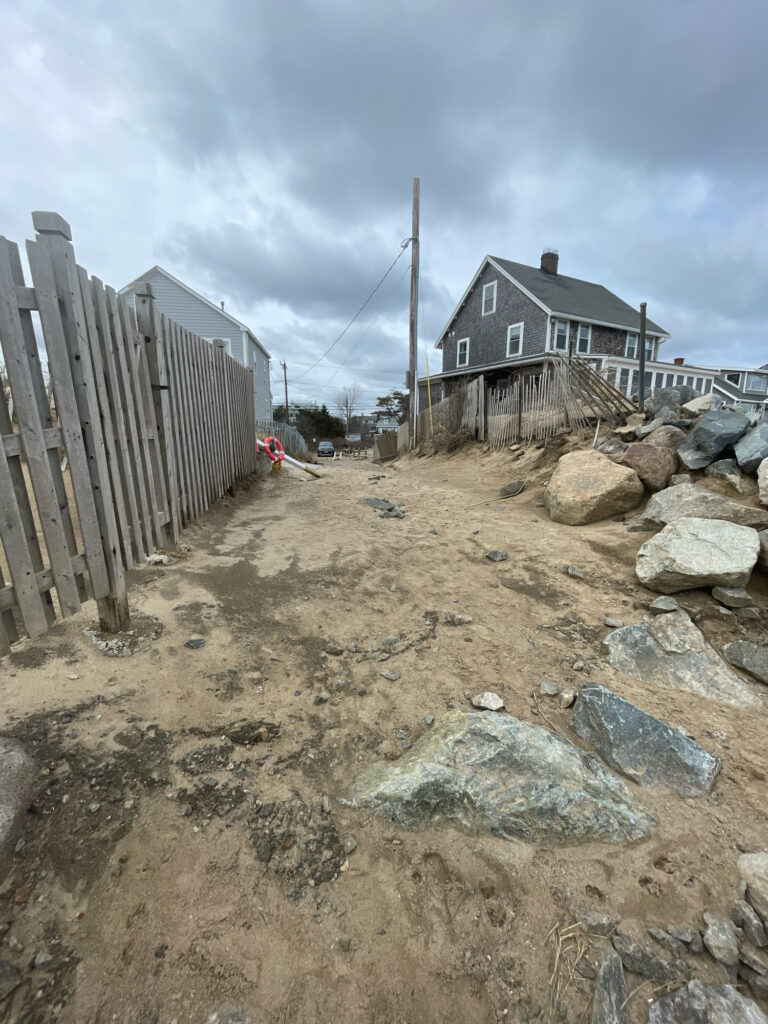 a rocky area with a house in the background (MyCoast AI)