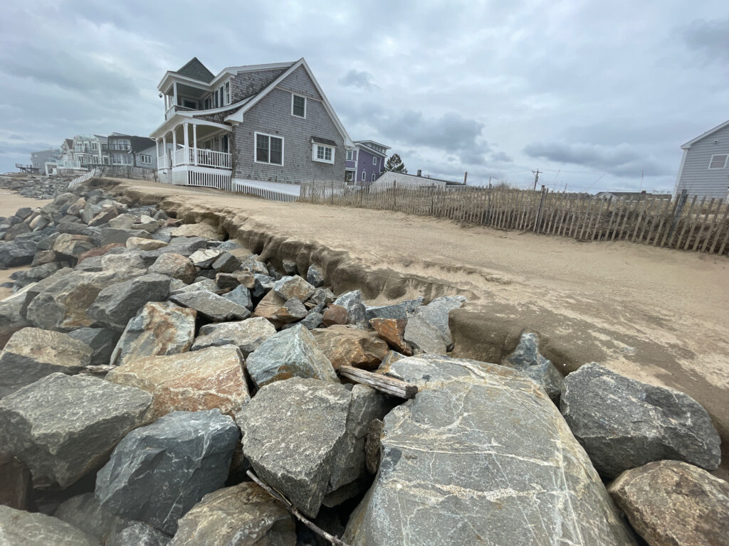 a rocky area with a house in the background (MyCoast AI)