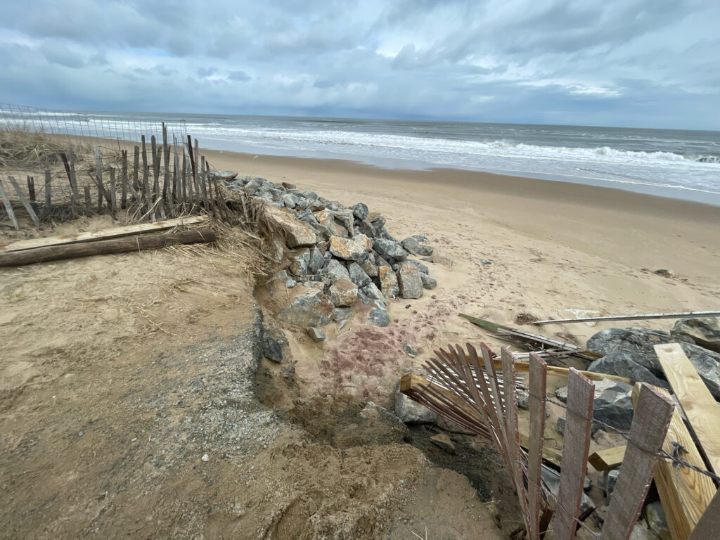 a beach with rocks and a fence (MyCoast AI)