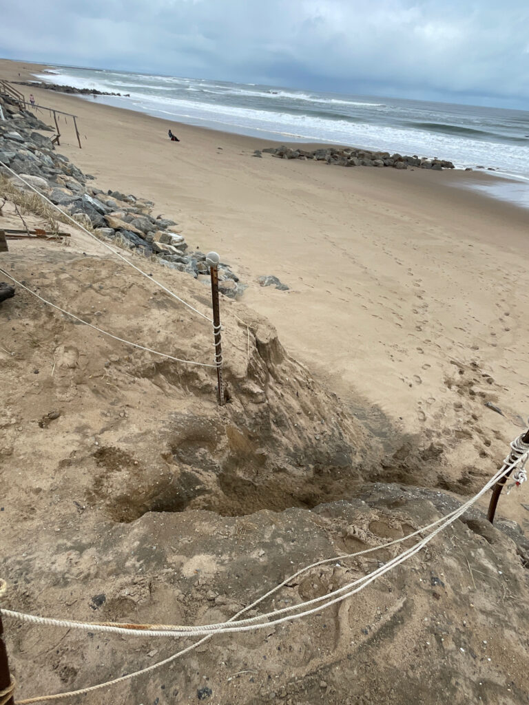 a sandy beach with a fence (MyCoast AI)