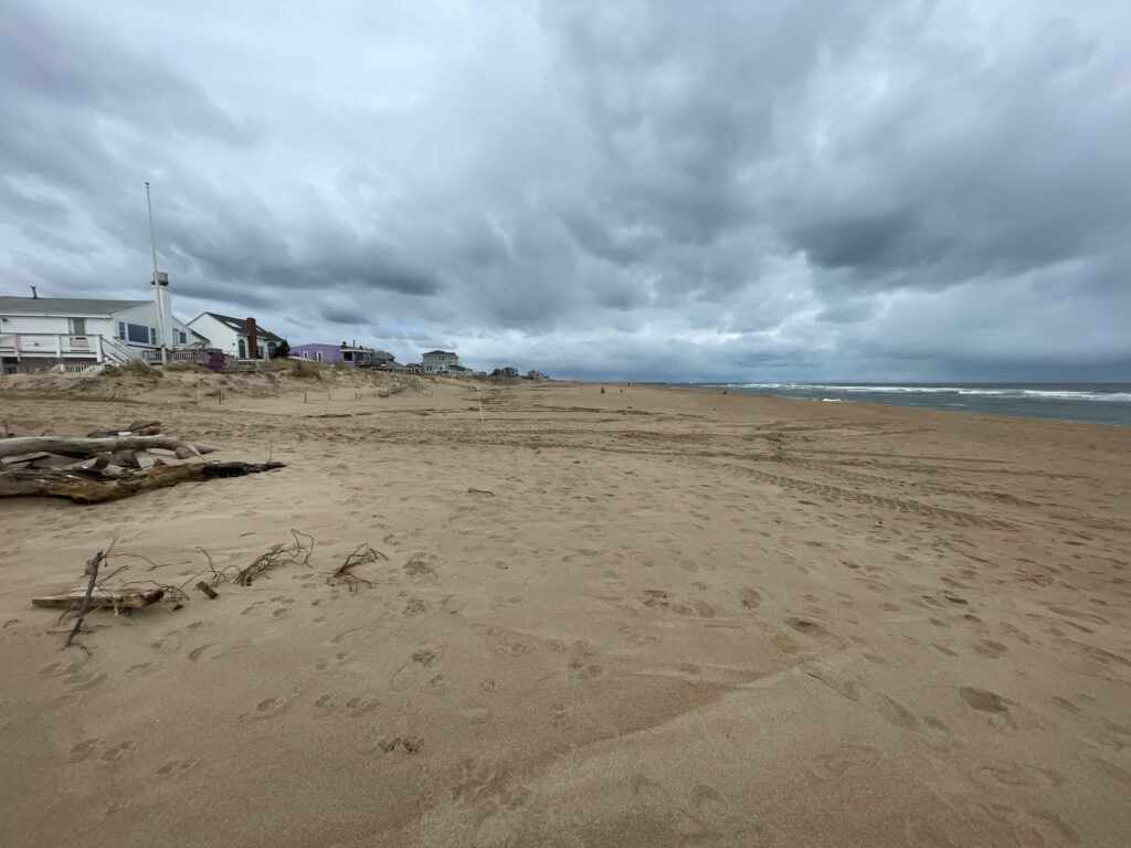 a sandy beach with a building in the distance (MyCoast AI)