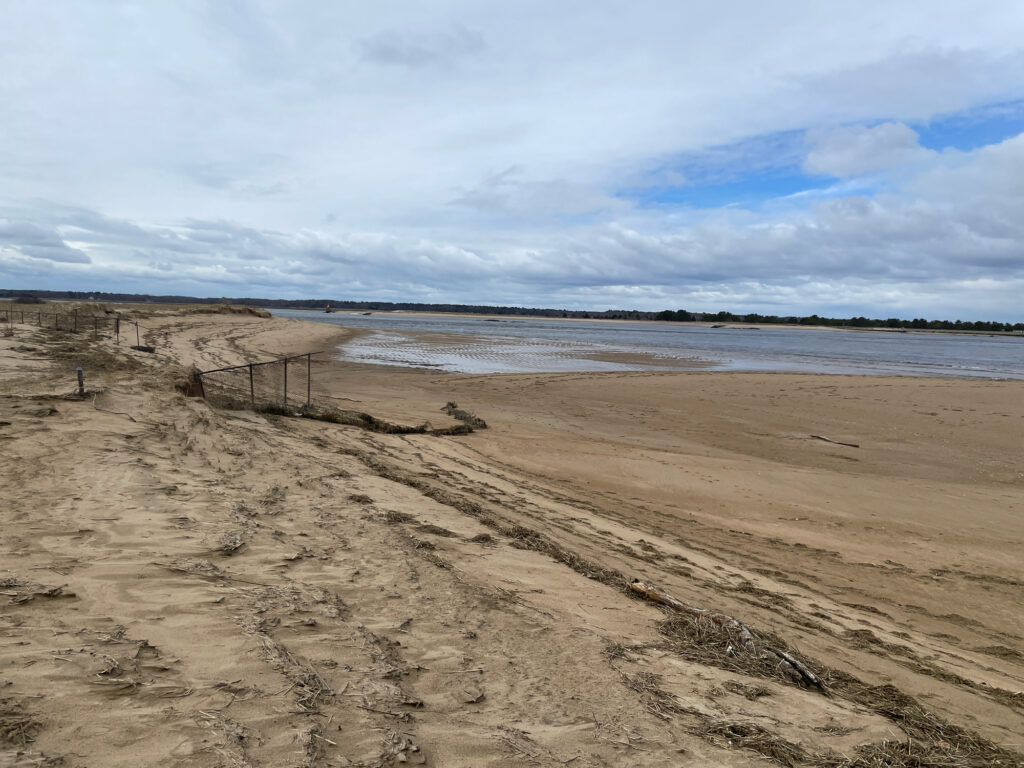 a sandy beach with a fence (MyCoast AI)