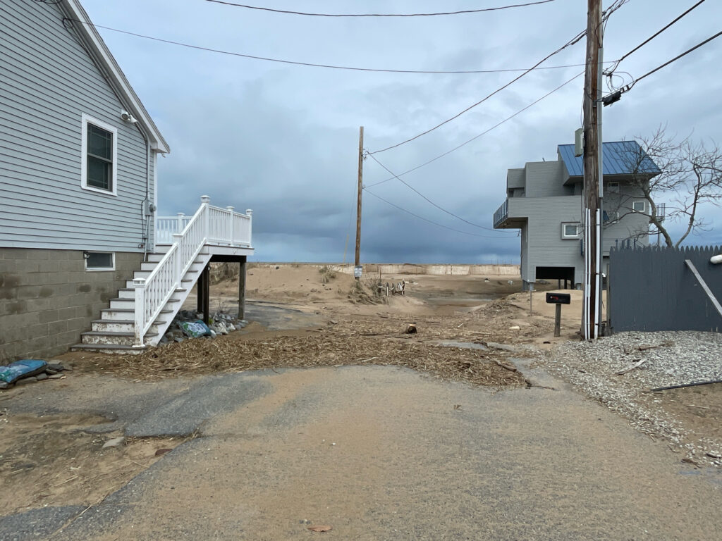 a dirt road with houses on either side of it (MyCoast AI)