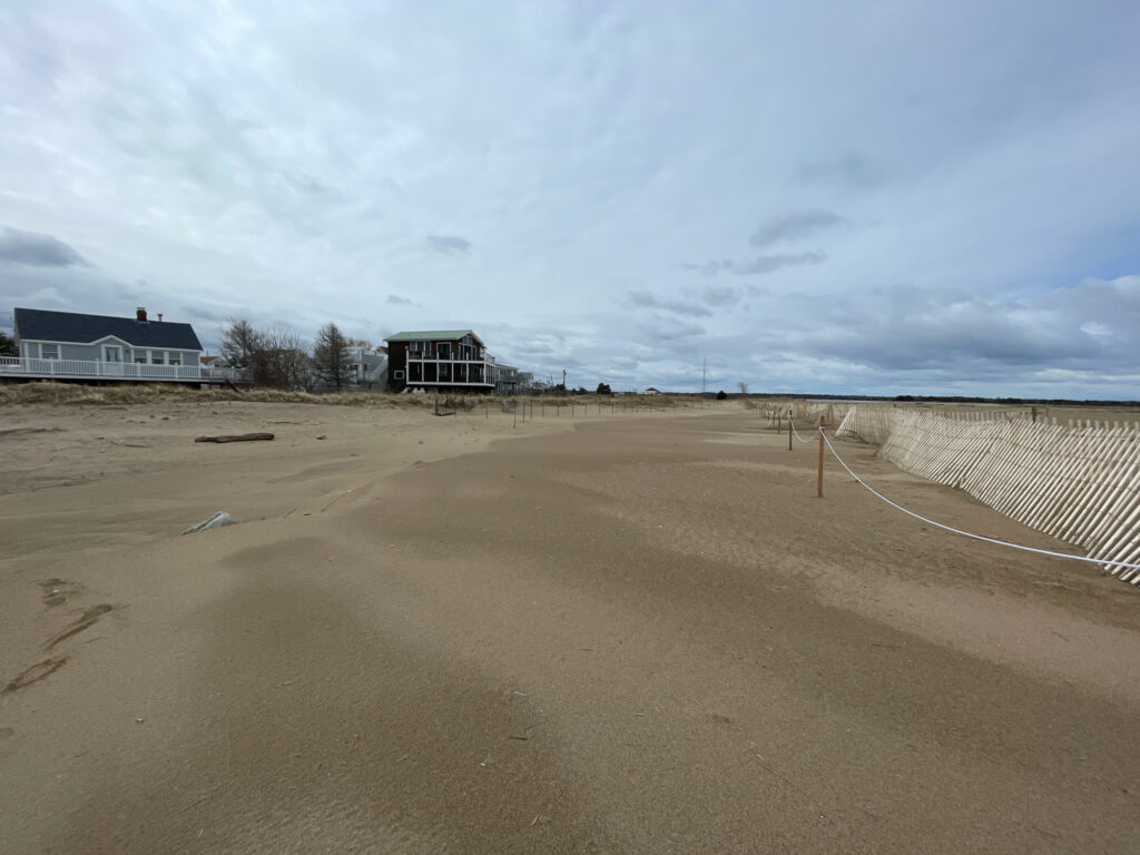 a dirt field with a building in the distance (MyCoast AI)