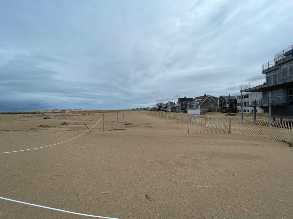 a dirt field with buildings in the background (MyCoast AI)