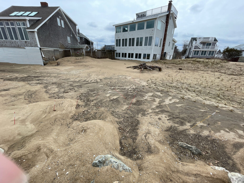 a dirt field with buildings in the background (MyCoast AI)