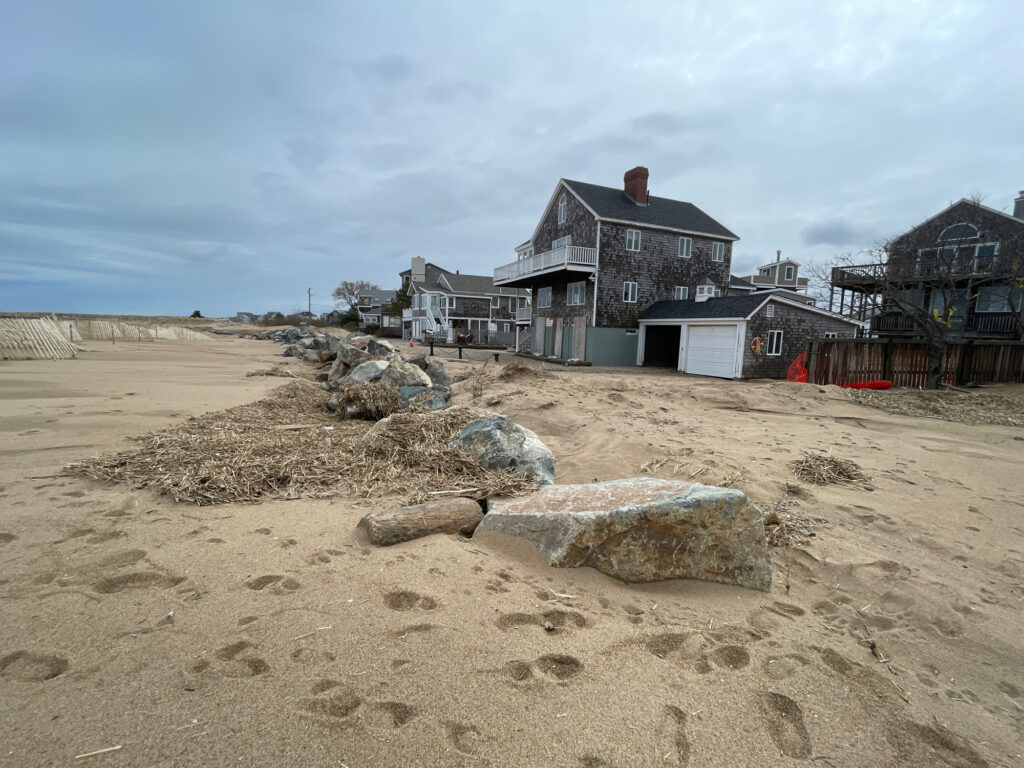 a sandy beach with houses in the background (MyCoast AI)