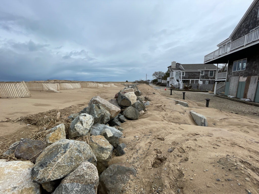 a rocky beach with buildings in the background (MyCoast AI)