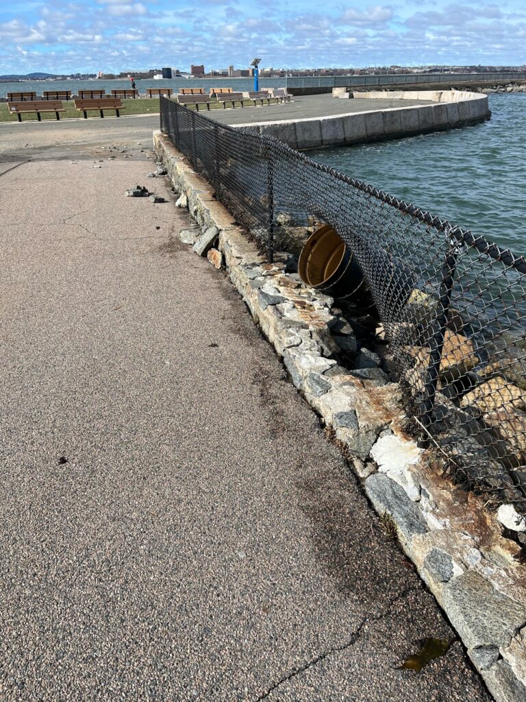 a concrete walkway next to a body of water (MyCoast AI)