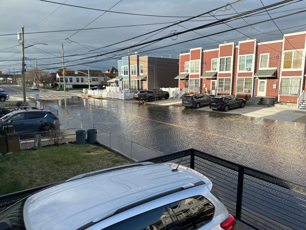 a flooded street with cars and buildings (MyCoast AI)