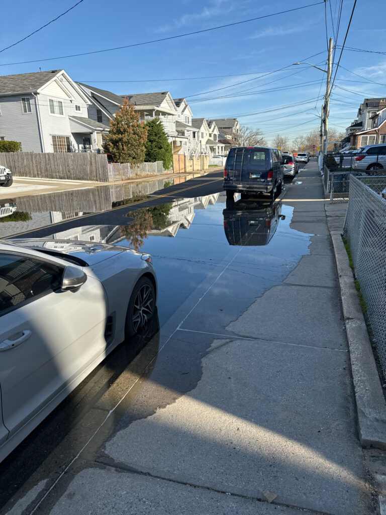a flooded street with cars and houses (MyCoast AI)