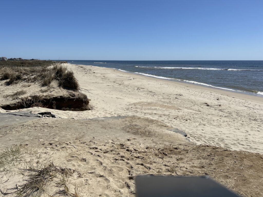 a sandy beach with waves crashing (MyCoast AI)